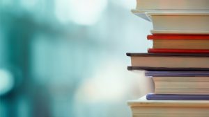 Book,Stack,In,The,Library,Room,And,Blurred,Bookshelf,For
